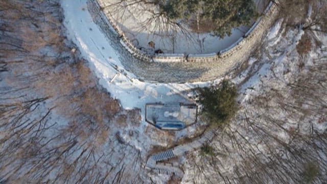 Ancient Fortress Wall in the Middle of a SnowyForest