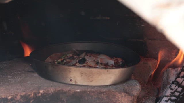 Pizza baking in a brick oven