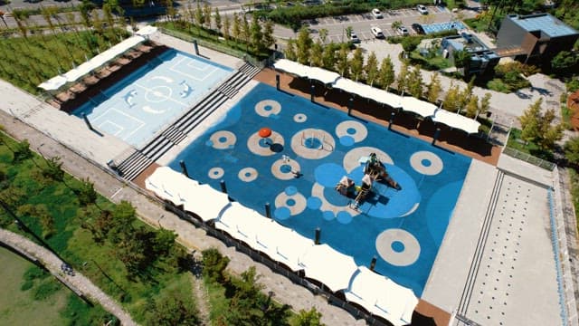 Aerial view of a modern playground and sports court