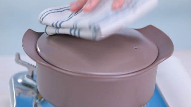 Mustard leaf kimchi stew with tofu boiling in a pot