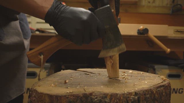 Chopping wood with an axe indoors