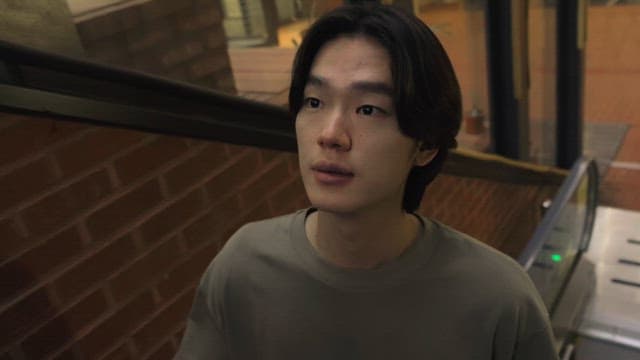 Man looking around on an escalator