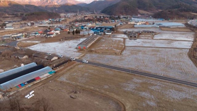 Convoy of Ambulances Driving Through Rural Area