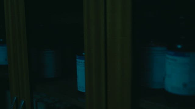 Dark laboratory room with chemical bottles on the shelf
