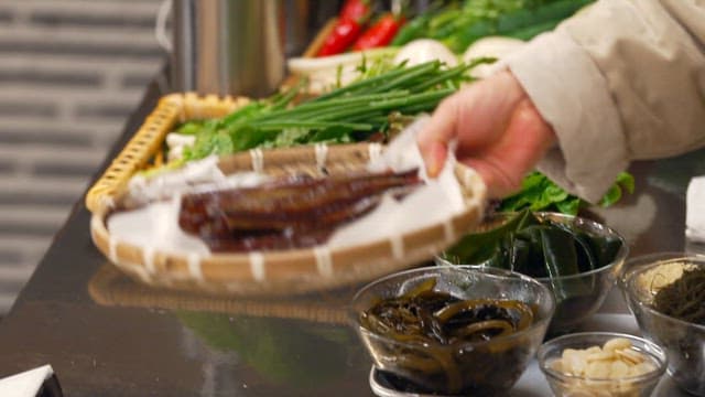 Wooden basket filled with half-dried saury in the kitchen