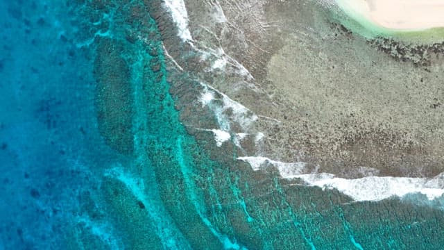 Coastline with waves crashing against the emerald sea
