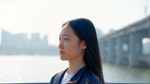Woman tying her hair by the riverside