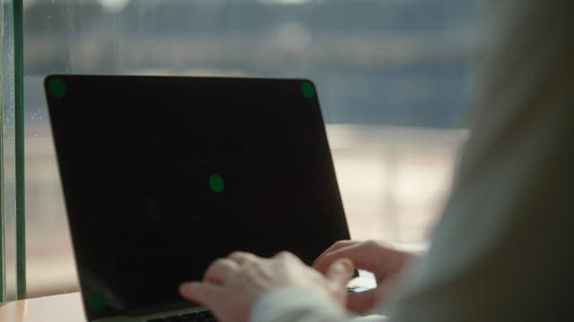 Person Typing on Laptop in Office