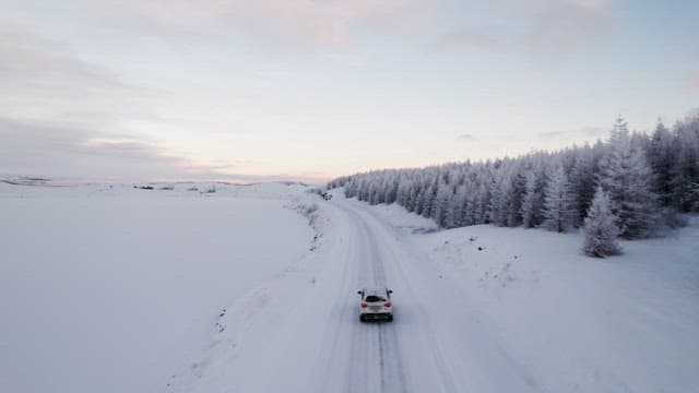 Car driving through a snowy landscape
