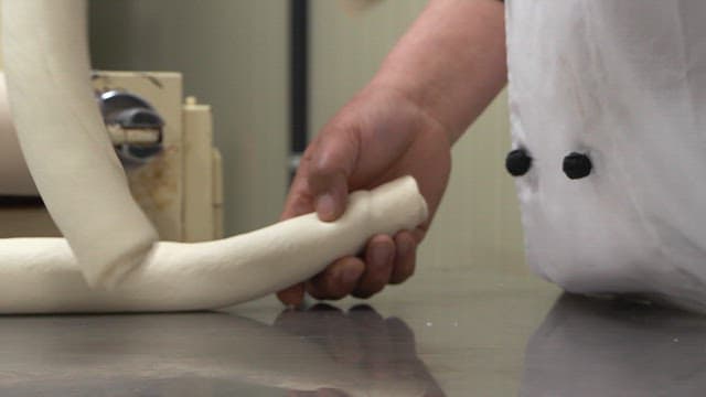 Chef twists dough into a twist shape