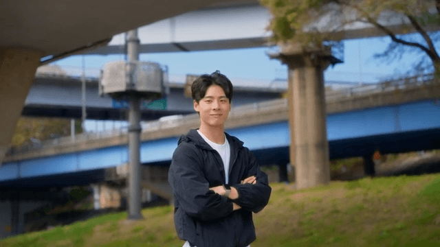 Man standing under a highway bridge