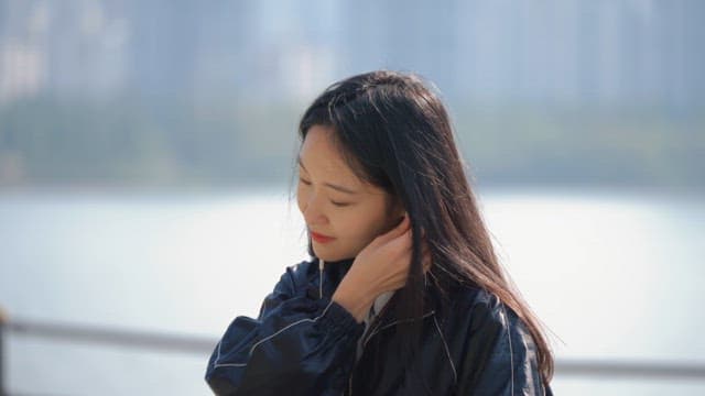 Woman listening to music by the riverside