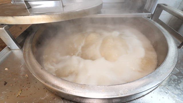 Boiling Broth in a large industrial pot with steam