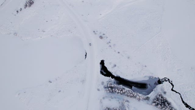 Car driving through a snowy landscape