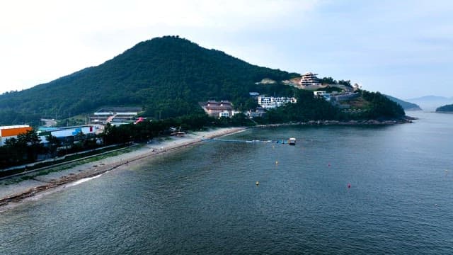 Coastal Landscape with Buildings on the Hill and Mountain