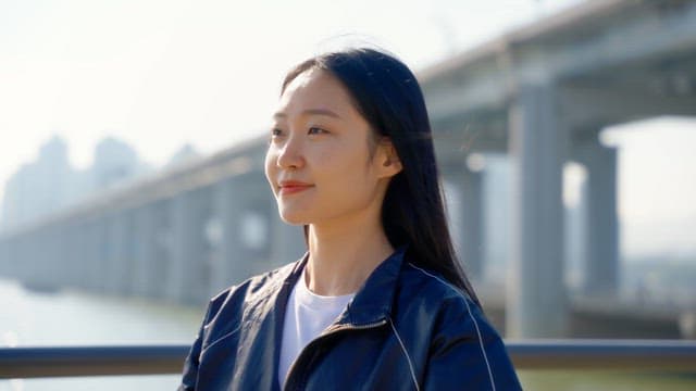 Woman tying her hair by the riverside