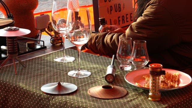 Camping tools and utensils decorating the cozy table in the tent