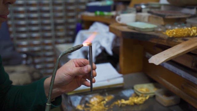 Artisan Crafting Jewelry in Workshop