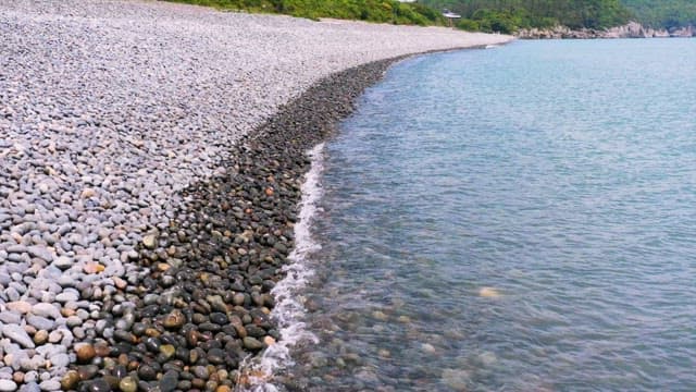 Serene Pebble Beach with Gentle Waves