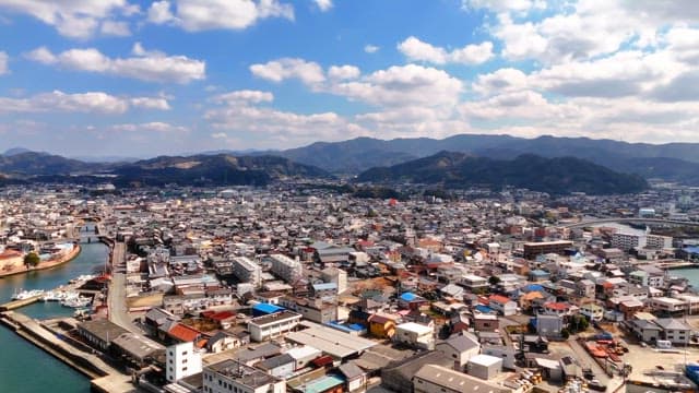 Coastal city with mountains in the background