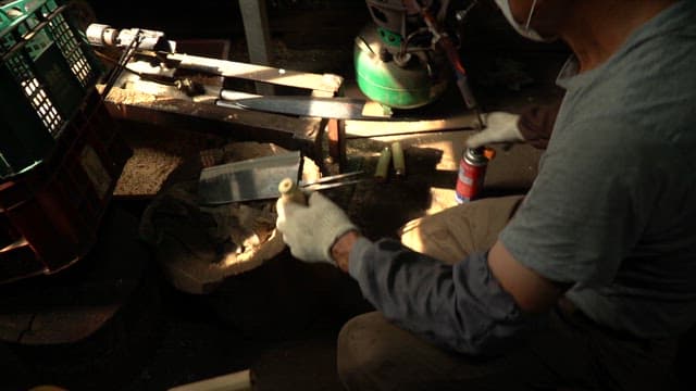Craftsman working with metal tools indoors