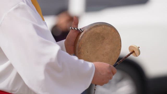 People wearing traditional clothes and performing samulnori