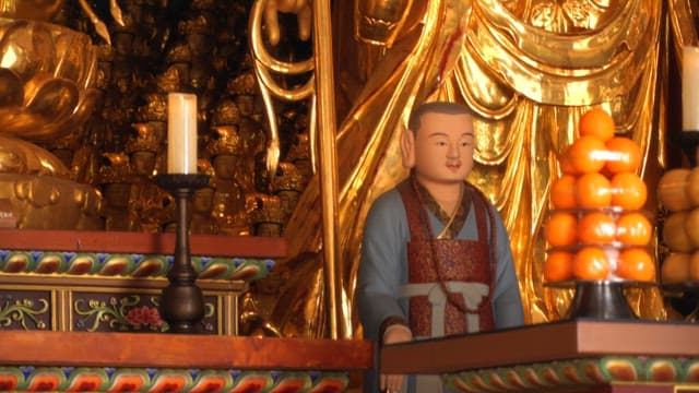 Golden Buddhist statues and offerings