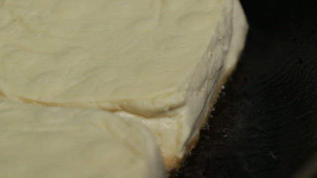 Tofu being fried in a pan