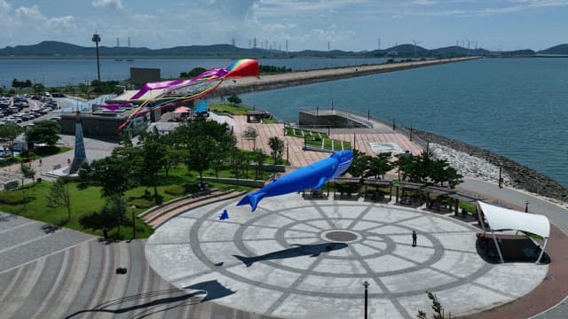Kiteflying in a Coastal Park on a Sunny Day