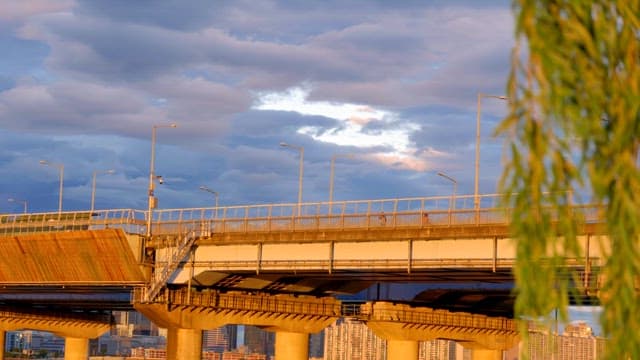 Bridge at sunset with cityscape