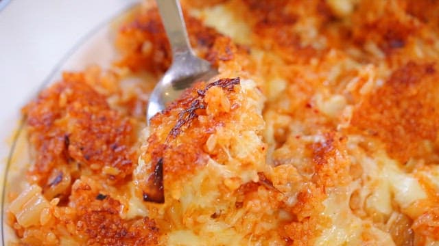 Spoonful of cheese-topped crispy rice