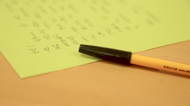 Letter in Yellow Paper and a Pen on a Desk