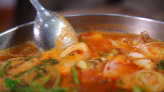 Spicy fish stew with fresh vegetables and trout oil