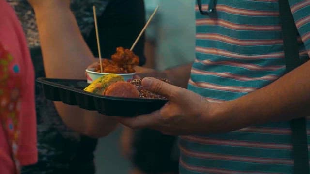 People Holding Lots of Street Food in Their Hands