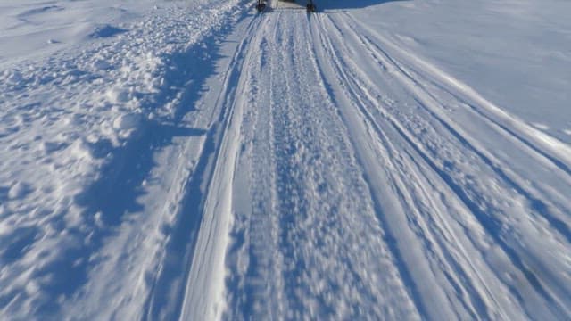 Snowmobile Ride Across a Snowy Landscape
