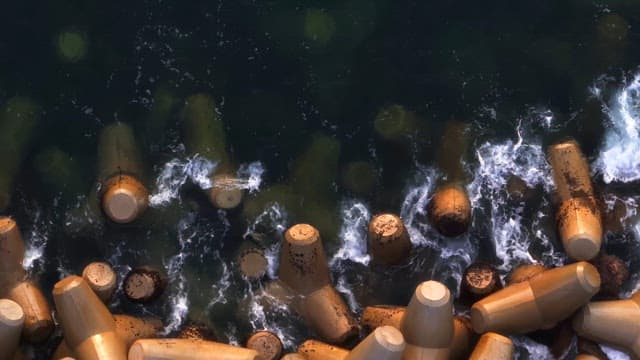 Waves crashing against concrete barriers