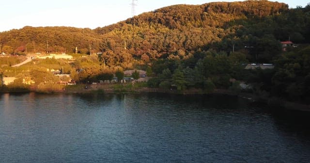 Serene lakeside with lush green hills