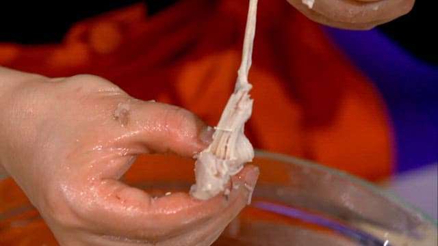 Ripping the cooked chicken by hand