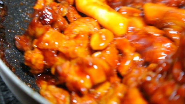 Spicy braised pork ribs with rice cakes cooked in a frying pan