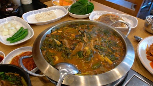 Table in a restaurant with a variety of food and side dishes