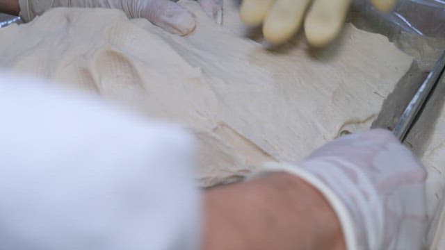 Preparing flour dough in a kitchen by hand with knife