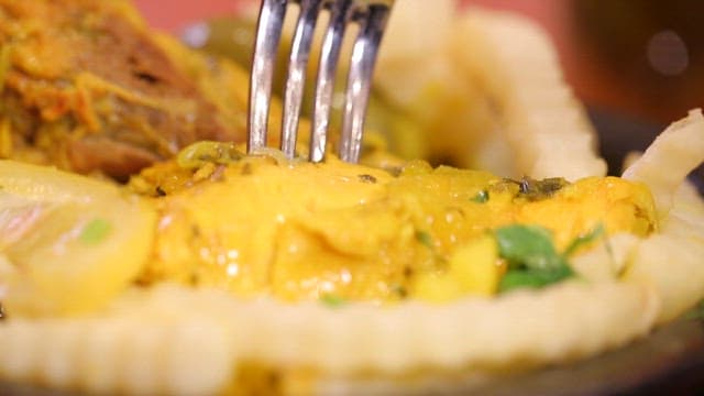 Delicious chicken dish being picked up with a fork