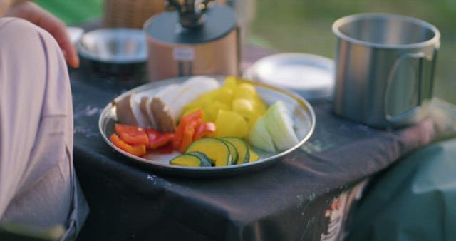 Preparing Fresh Vegetables at a Campsite