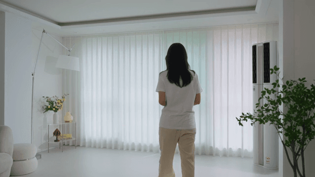 Woman walking through modern living room with white interior