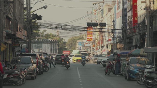 Busy urban street with traffic and pedestrians in the daytime