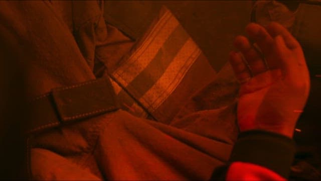 Firefighter Looking at His Hand at the Scene of a Fire