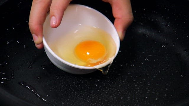 Cracking an egg into a hot pan