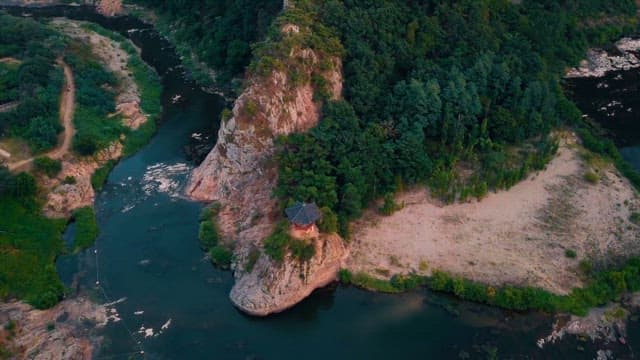 A Serene River by a Lush Mountain with Pavillon