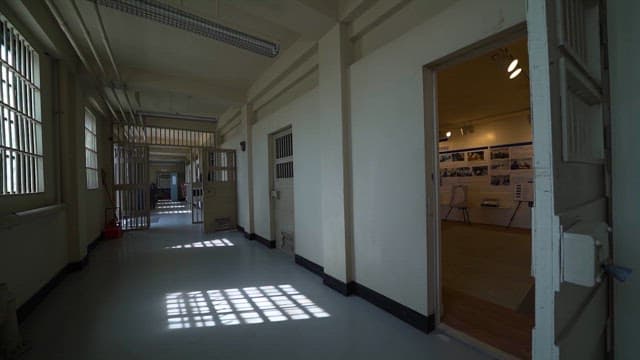 Prison Hallway with Barred Windows