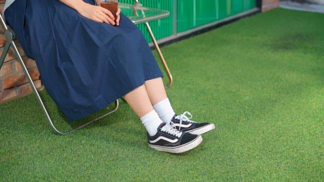 Legs of young woman relaxing with coffee